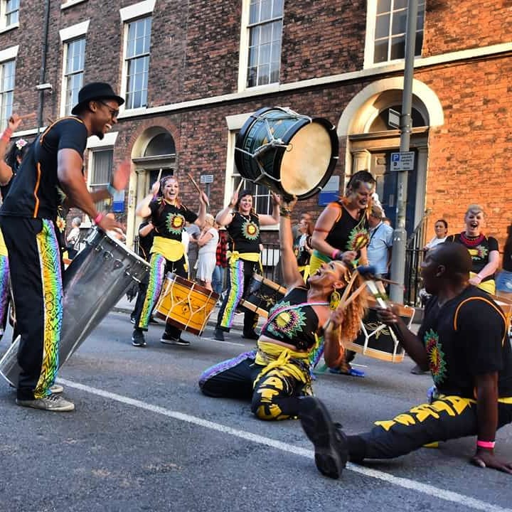 Drummers dancing doing the splits carnival parade