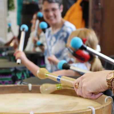 happy women and child playing drums