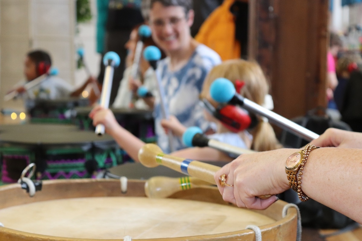 happy women and child playing drums